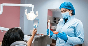 Dentist consulting with a patient in a bright clinic